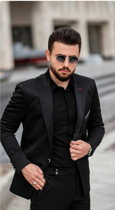 Man in black suit and black shirt